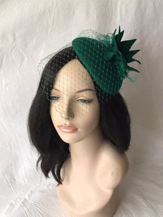 "Absolutely perfect for this season, is this wool felt Dark Forest Green Ladies cocktail Fascinators Hats ideal as a Formal Tilt Hats, Tea Party hat, Kentucky Derby Race Day Hat, Wedding Headpiece, Women's Church hat or any other special occasion, unique gift for the fashionista, mother, sister, wife and \"her\". EASY TO WEAR and HOW TO WEAR Simple and light weight with elastic band underneath and alligator clip to allow you the options and freedom to wear on both sides, in the middle for a vint Green Short Brim Felt Hat For Kentucky Derby, Green Evening Fascinator Hat, Green Evening Hat, Green Fitted Fascinator For Church, Green Headpieces For Church And Kentucky Derby, Vintage Green Hat For Wedding, Elegant Green Cloche Hat, Vintage Fitted Felt Hat For Party, Vintage Green Brimmed Mini Hats