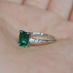 Breathtaking minimalist style green emerald ring, with a 1.2ct emerald in the middle, with a pear stone and two round stone on each side, simple but elegant design, can also wear with different bands, to make a unique match, beautiful and special gift for someone you loved or for yourself, we all worth beautiful items. ❥Details: Material: Solid 14K Gold Main Stone: 1.25ct Lab Created Emerald Cut: Emerald Side Stone: CZ/Moissanite CSG076 See other gold items in our shop: https://www.etsy.com/shop Elegant Emerald Birthstone Proposal Ring, Formal May Birthstone Emerald-cut Emerald Ring, Emerald Ring For Proposal, May Birthstone, Fine Jewelry, Formal Green Emerald-cut Crystal Ring, Luxury Square-cut Emerald Ring For May Birthstone, Gold Emerald Ring, Gold Items, Green Emerald Ring, Emerald Ring Gold