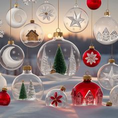 an assortment of christmas ornaments hanging from strings in the snow, with houses and trees inside them