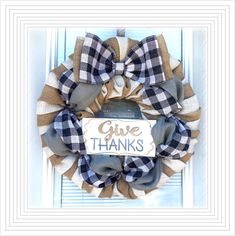 a black and white wreath with a give thanks sign on it