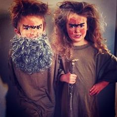 two children dressed in costumes standing next to each other with fake hair and beards