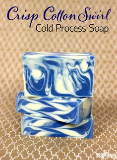 three soap bars stacked on top of each other in blue and white swirled designs,