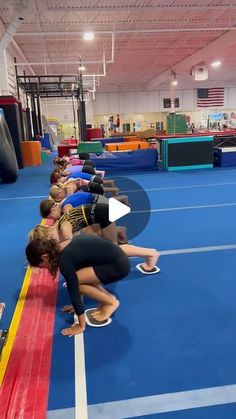 a group of people standing on top of a blue and yellow floor next to each other