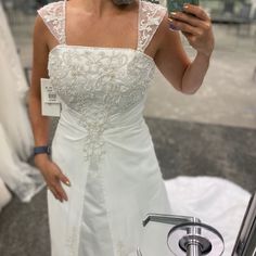 a woman taking a selfie in her wedding dress