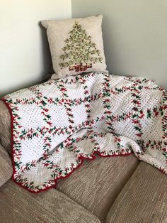 a christmas tree quilted on top of a couch with two pillows and a pillow case