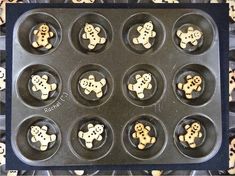 a muffin tin with twelve cookies shaped like gingerbreads in the shape of teddy bears