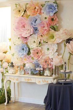 a table topped with lots of pink and blue flowers