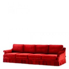 a red couch sitting on top of a white floor