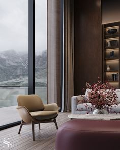 a living room filled with furniture and a large window overlooking the mountain range in the distance