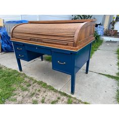 a blue desk sitting on top of a sidewalk