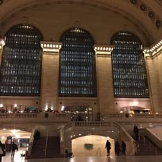 people are walking around inside the grand central station in new york city at night time