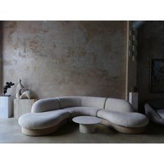 a white couch sitting in front of a wall