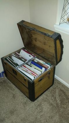 an old trunk is filled with files in the corner