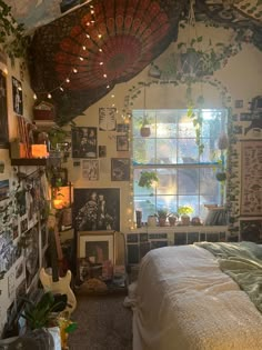 a bedroom with lots of plants and pictures on the wall