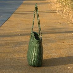 This woven leather handbag is handy. 'Carla' tote that's perfect for everyday use. It features soft yet durable vegetable tan calf leather. Handmade by experienced artisan. Vegetable tanned calf leather - soft and durable.  Use delicate cream to clean and care for the leather. Everyday Bucket Bag With Intrecciato Weave, Intrecciato Weave Bucket Bag For Everyday Use, Green Top Handle Straw Bag For Everyday Use, Green Woven Leather Tote Shoulder Bag, Green Satchel Bag With Intrecciato Weave, Green Tote Bag With Intrecciato Weave, Green Straw Bag With Braided Handles For Everyday, Everyday Green Shoulder Bag With Intrecciato Weave, Green Woven Leather Shoulder Bag For Errands