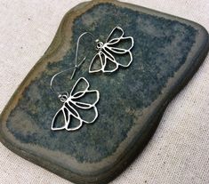 "These are unique, funky and whimsical silver flower earrings! They have such a fun and playful vibe with their modern design style. They are lightweight and comfortable. The perfect everyday earring, versatile and stylish. The earrings measure 5/8\" long by 1\" wide and hang from simple silver ear wire hooks. Overall drop length is 3/4\". Made from allergy free plated rhodium and silver. I have a matching necklace in my shop, if you would like the whole set. Here is the link Thanks for stopping Whimsical Silver Flower Earrings, Whimsical Silver Flower Earrings With Ear Wire, Whimsical Nickel-free Flower Earrings As Gift, Whimsical Nickel-free Flower Earrings For Gifts, Silver Whimsical Flower Earrings, Whimsical Silver Dangle Flower Earrings, Nickel-free Whimsical Drop Flower Earrings, Whimsical Nickel-free Drop Flower Earrings, Flower Earrings Silver