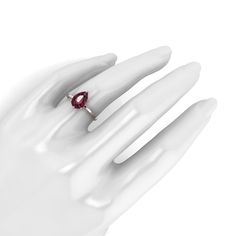 a woman's hand with a ring on it and a red stone in the middle