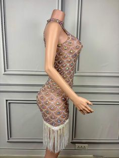 a mannequin wearing a dress with sequins and beads on the sides