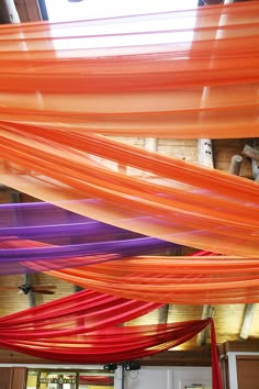 an orange and purple streamer is hanging from the ceiling