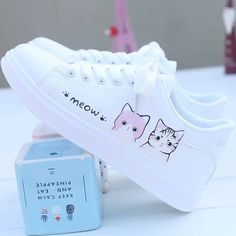 Stylish cat-themed sneakers, white, comfy, lace-up Trendy White Canvas Shoes With Laces, Cute Lace-up Canvas Shoes With White Sole, Cute Lace-up Sneakers With White Sole, Comfortable White Canvas Shoes, Trendy White Flat Skate Shoes, Comfortable White Flat Sneakers, Cute White Sneakers With Vulcanized Sole, Trendy White Canvas Shoes With Vulcanized Sole, Cute Low-top Canvas Shoes With White Sole