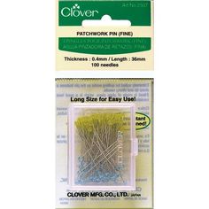 clover sewing pins in plastic package with yellow and blue needles on the inside of it