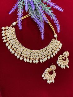 High gold plated designer Tyaani Kundan set with matching Chandbali. Next to real anti tarnish platting, hypoallergenic. Suitable for anything . Can be worn as a necklace or choker. About 1.5 inch wide on the neck. Earring is 2 inch long , push back and very very light weight . White Kundan Choker With Hand-set Details, White Gold Plated Chandbali Necklace, Intricate Design Kundan Choker Necklace For Celebration, Kundan Choker Necklace With Intricate Design For Celebration, White Gold-plated Chandbali Necklace, Ceremonial Heavy Kundan Choker Necklace, Ceremonial Chandbali Choker With Intricate Design, Heavy Temple Choker Necklace For Festive Occasions, Festive Heavy Temple Choker Necklace