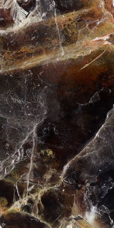 an image of marble that looks like it has been painted black and white with gold accents