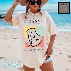 Modern abstract art Picasso tee. This is the vintage style Comfort Colors shirt with a trendy design that women adore. When ordering, please refer to size chart.  Please refer to size chart for best fit and order up 1-2 sizes for an oversized look. NO RETURNS OR EXCHANGES Gildan is back with its garment-dyed t-shirt, a fully customizable tee made 100% with ring-spun cotton. The soft-washed, garment-dyed fabric brings extra coziness to your wardrobe while the relaxed fit makes it an excellent dai Artistic White Summer T-shirt, Artsy Cotton Summer Shirt, Artsy Cotton Shirt For Summer, Summer Graphic Print T-shirt For Artistic Expression, Vintage Graphic Design Shirt For Summer, Vintage Summer Shirt With Graphic Design, Artsy Oversized Graphic T-shirt, Artsy Oversized Graphic Print T-shirt, Oversized Artsy Graphic Print T-shirt