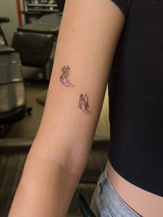 a woman's arm with a small tattoo on the left side of her arm