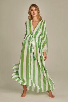 Empress Brasil Luxury Beachwear Trancoso Collection. The Santorini Maxi kaftan is a sultry beach coverup in our Green Stripes Print. The Kaftan comes in one size and has a tassle and bead detail hanging in the front. The style is feminine and classic but the acrylic bead and tassle detail give it a modern twist. The light and airy material make this the perfect beach kaftan. Material: 100% polyester. Casual Green Kaftan For Beach Cover-up, Tropical Green Kaftan For Beach Cover-up, Green Digital Print Kaftan, Bohemian Striped Kaftan For Beach Cover-up, Spring Striped Kaftan For Beach Cover-up, Luxury Beachwear, Beige Palette, Beachwear Brands, Beach Kaftan