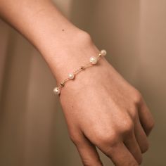 A minimalistic dainty bracelet with natural freshwater pearls seamlessly blends elegance with minimalism. This bracelet is perfect for everyday wear or as a gift that will be treasured for years. ----------------------------------------------   FEATURES: * Delicate design suitable for everyday wear or special occasions. * Stainless steel with 14K gold plating that will not tarnish over time. * Crafted to order with attention to detail. Chain Length: approximately 6.3'' + 1.6'' extension. ------- Delicate Formal Bracelets With Pearl Charm, Feminine Pearl Bracelet With Charm For Wedding, Dainty Pearl Beaded Bracelets For Formal Occasions, Delicate Pearl Charm Bracelet For Formal Occasions, Dainty Pearl Chain Beaded Bracelets For Formal Occasions, Minimalist Wedding Bracelet With Delicate Chain, Rose Gold Minimalist Pearl Bracelet For Everyday, Delicate Pearl Beaded Bracelets For Formal Occasions, Delicate Pearl Beaded Bracelets For Formal Events