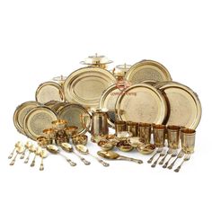 an assortment of gold colored dishes and silverware