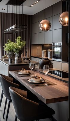 a modern kitchen with wooden counter tops and dark colored cabinets, along with hanging lights above the island