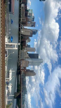 the city is surrounded by tall buildings and clouds