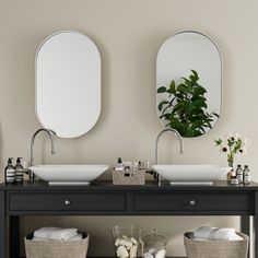 there are two sinks in the bathroom with mirrors on the wall above them and baskets underneath it