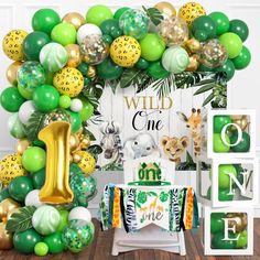 a jungle themed birthday party with balloons and decorations