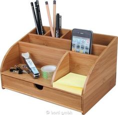 a wooden desk organizer with cell phone and pens