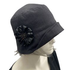 HANDMADE IN THE USA The classic Eleanor style 1920s cloche hat. A must for all flapper events including Jazz age Lawn Parties and Dapper Days! This lovely hat can also be worn to weddings, garden parties, or simply a walk along the beach. Featuring a narrow brim that can be worn tilted up or left down. This style of hat is very reminiscent of those worn in the 1920s by the stylish flappers of the time.This couture hat is made with medium weight linen and accented with satin ribbon flower brooch Jazz Age Lawn Party, 1920s Hat, Bespoke Hats, Downton Abbey Fashion, Lawn Party, Satin Ribbon Flowers, Couture Hats, 1920s Vintage, Dapper Day