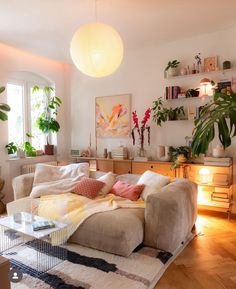 a living room filled with furniture and lots of plants