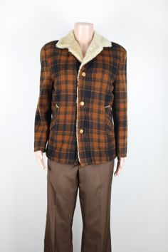 This is the perfect jacket to add to your Winter wardrobe for this cold season, and every chilly day to come. It has a beautifully soft thick faux fur lining, and a very warm woolen plaid exterior. It also has 2 side pockets, a large sherpa collar, and 3 creamy brown buttons down the front. Please note that this jacket has had a few tiny repairs. These can be seen int the last images shown above.  Fabric: 25% Mohair 70% Wool, and 5% Nylon Brand: Alpine. Colour: Dark orange and black check. Size & Measurements: This jacket is a mens size small, or an Australain Womens size 10. Sleeve length: 60cm from shoulder to cuff. Jacket Length: 68cm from collar to hem. Chest: 104cm around chest. Follow Morris and Grant Vintage on Instagram and Facebook to see all new and upcoming vintage items, find o Vintage Sport Coat With Pockets For Cold Weather, Collared Brown Sport Coat For Winter, Brown Collared Sport Coat For Winter, Vintage Collared Blazer For Winter, Retro Brown Outerwear For Cold Weather, Retro Brown Sport Coat For Winter, Retro Brown Winter Outerwear, Vintage Collared Winter Outerwear, Retro Wool Sport Coat For Winter