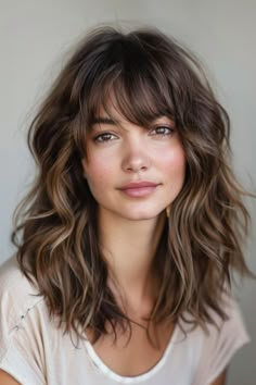 Medium length wavy hairstyles deliver a blend of versatility and chic, easy-going style. Click for more inspiration. Medium Hairstyle Women Wavy Hair, Piecey Bangs Medium Hair, Mid Length Medium Brown Hair, Wavy Hair With Bangs Medium, Wavy Hairstyles Medium With Bangs, Medium Length Haircut With Layers Wavy, Wavy Perms For Medium Length Hair, Medium Length Wavy Hair With Layers And Bangs, Wavy Thick Haircut