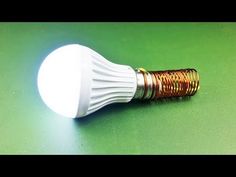 a white light bulb sitting on top of a green table