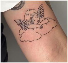 a tattoo on the arm of a woman with an angel and cloud in the sky