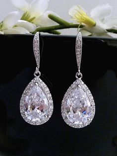 This earring features a tarnish resistant White gold plated metal framed AAA high quality clear white cubic zirconia teardrop, hang from a white gold plated over sterling silver cubic zirconia earwire. Size: 3.8 cm x 1.4 cm or 1.52 x 0.56 inches  I have a matching necklace to this earring: Listing: http://www.etsy.com/listing/101100145/bridal-necklace-high-quality-large-clear GOLD Version is also available. **NOTE: CUBIC ZIRCONIA HAS MANY DIFFERENT GRADES, AND ALL THE CUBIC ZIRCONIA USED IN MY DESIGN IS OF THE HIGHTEST QUALITY. IT SPARKS LIKE DIAMOND AND MUCH PRETTIER IN PERSON)  **Express Shipping available, delivery in about 3 business days , please contact me for rates. **Please see policy: https://www.etsy.com/shop/JCBridalJewelry/policy?ref=shopinfo_policies_leftnav **For more bridal Classy Earrings, Bride Earrings, Wedding Bridal Jewellery, Cz Earrings, Clear White, Gold Plated Bracelets, Antique Earrings, Large Earrings, Bridal Jewelry Sets