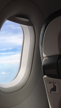 an airplane window looking out at the sky