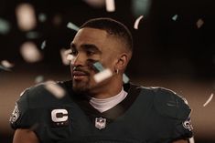 a close up of a football player with confetti in the air