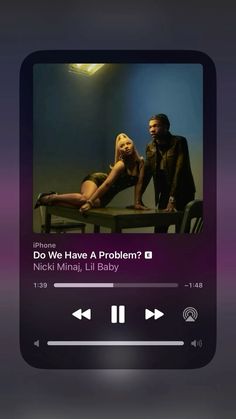 the music player is playing an album on her phone screen, and it appears to be showing that she's pregnant