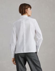 Stretch cotton poplin shirt with shiny ribbed detail Precious details update the essential style of this stretch cotton poplin shirt. The chest pocket is enriched with a delicate ribbed edge illuminated by a monili embroidery, adding a feminine touch to the garment’s classic lines. The slightly full effect of the sleeves highlights the shirt’s contemporary feel. Timeless Daywear Tops With Placket, Timeless Long Sleeve Tops With Concealed Placket, Timeless Tops With Placket For Daywear, Timeless Tops With Placket And Fold-down Collar, Timeless Tops With Fold Down Collar And Placket, Classic Formal Poplin Blouse, Timeless Long Sleeve Cotton Blouse, Relaxed Fit Poplin Top For Work, Elegant Long Sleeve Poplin Shirt