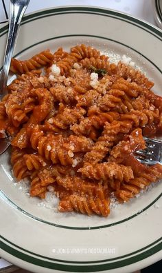 a white plate topped with pasta covered in sauce