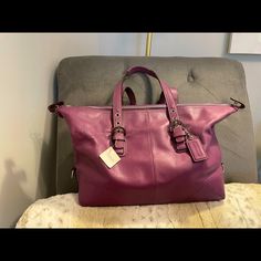 2 Bags In 1! This Bag Can Be Carried 2 Different Ways! A Beautiful Color - Berry!! Style Number F17220 13.5l X 4.5w X 11.5h Designer Leather Duffle Bag For Shopping, Elegant Everyday Duffle Bag With Handles, Luxury On-the-go Duffle Bag, Satchel Duffle Bag With Detachable Strap For Shopping, Leather Top Handle Duffle Bag For Shopping, Shopping Duffle Bag With Detachable Strap And Satchel Shape, Duffle Bag With Detachable Strap Satchel For Shopping, Modern Leather Duffle Bag For Shopping, Leather Duffle Bag With Double Handle For Shopping